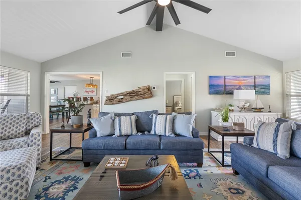 a kitchen with a stove and wooden floor