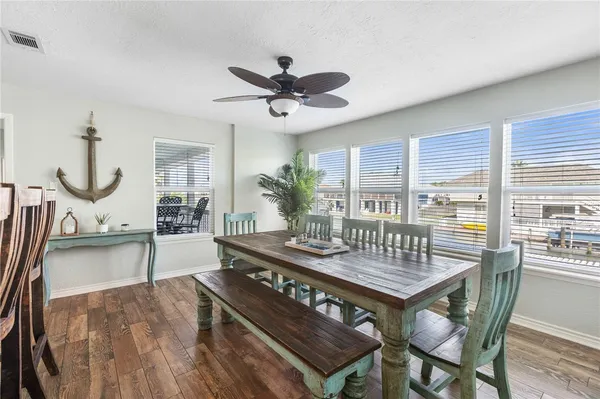 a view of a dining room with furniture and a potted plant