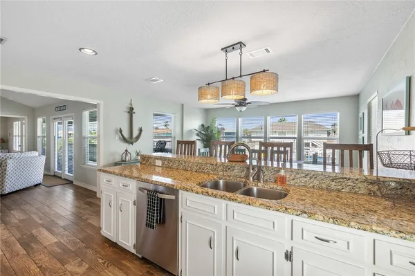 a bedroom with a bed and large windows