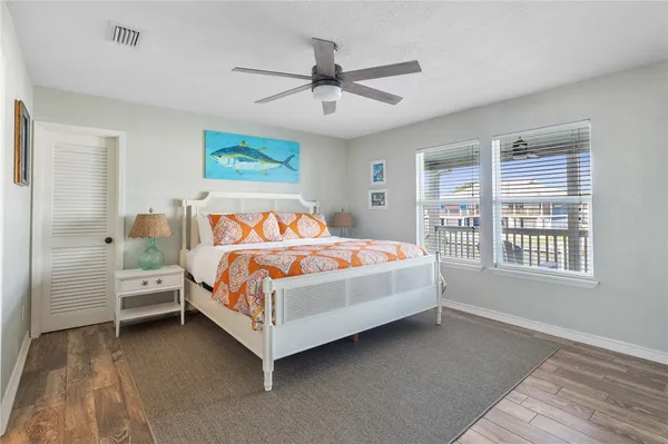 a bedroom with a bed and a flat screen tv on dresser