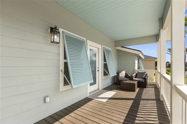 a view of a balcony with wooden floor
