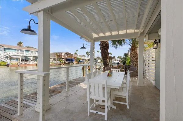 an aerial view of a house with swimming pool and lounge chairs