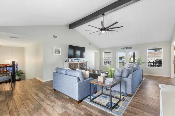 a living room with furniture and wooden floor