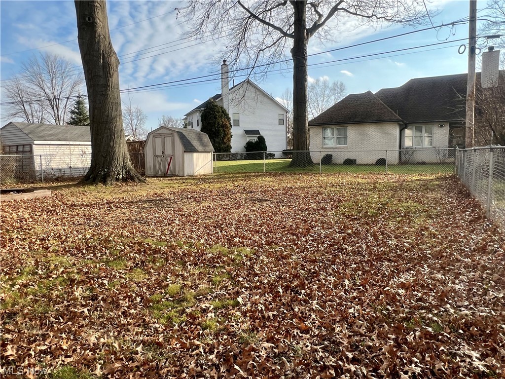 229 Hilliard Road Elyria, OH 44035 - Photo 26 of 28 View of backyard featuring a storage unit