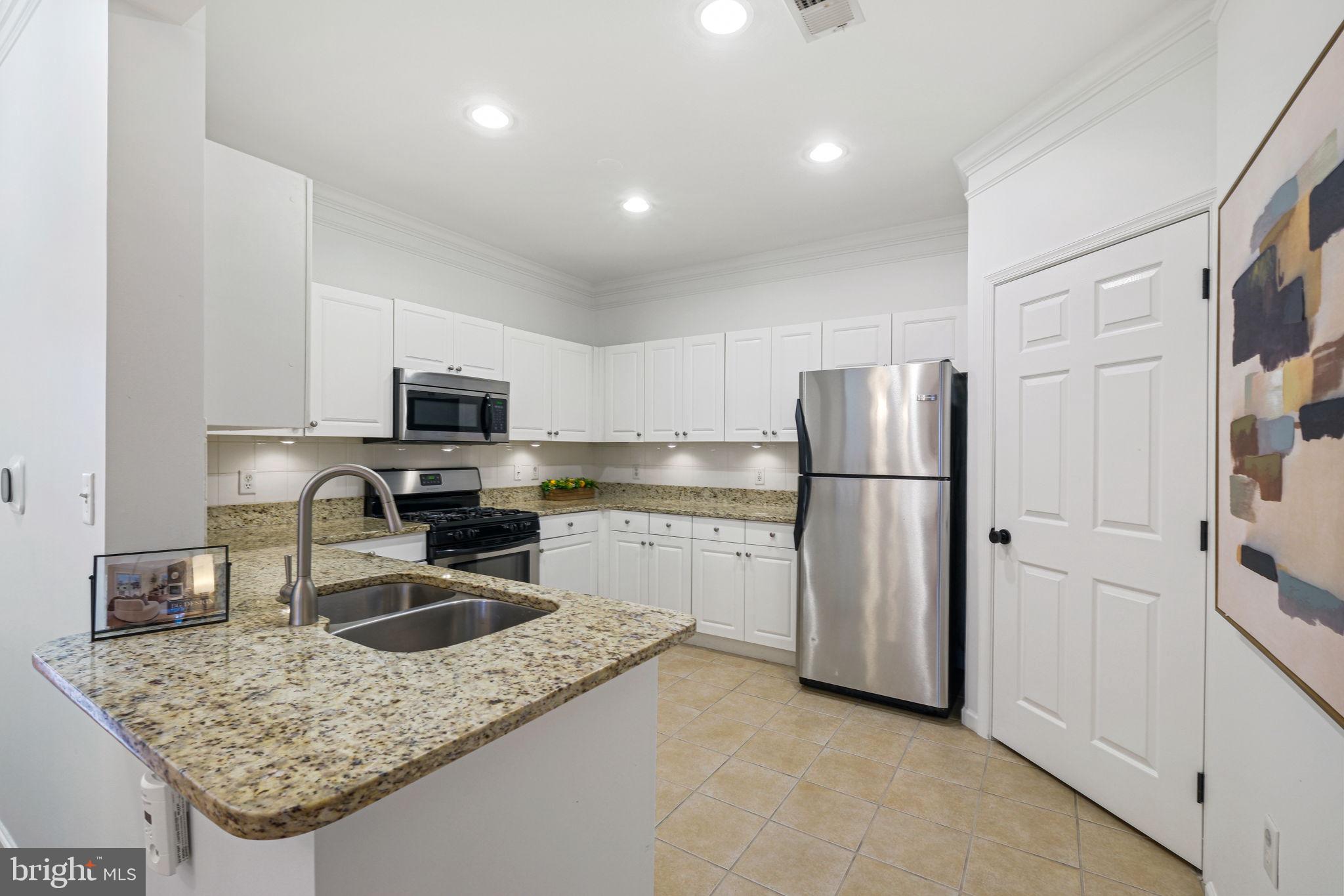 8 Granite Place, Unit 266 Gaithersburg, MD 20878 - Photo 11 of 49 a kitchen with refrigerator cabinets and wooden floor