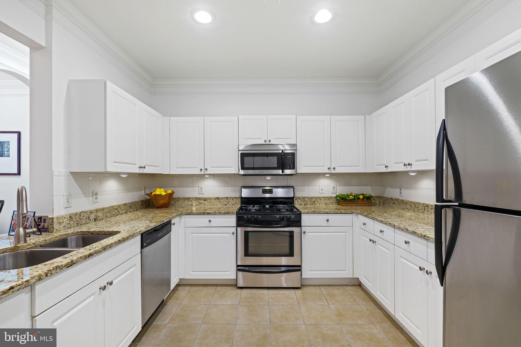 8 Granite Place, Unit 266 Gaithersburg, MD 20878 - Photo 12 of 49 a kitchen with white cabinets and white appliances