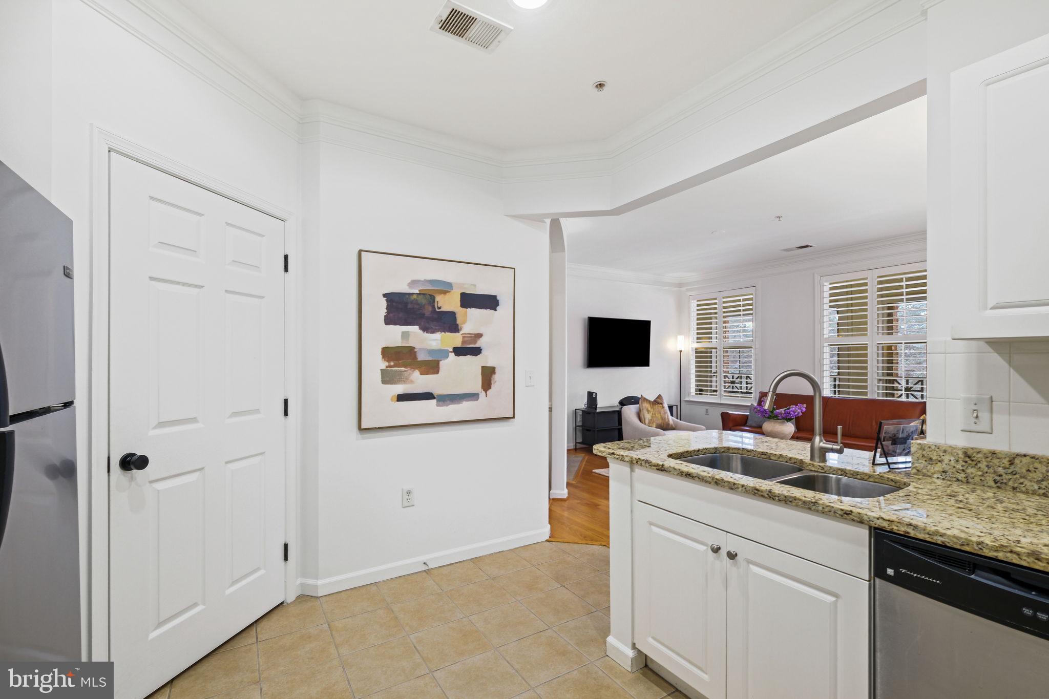 8 Granite Place, Unit 266 Gaithersburg, MD 20878 - Photo 13 of 49 a kitchen with stainless steel appliances granite countertop a sink and a refrigerator