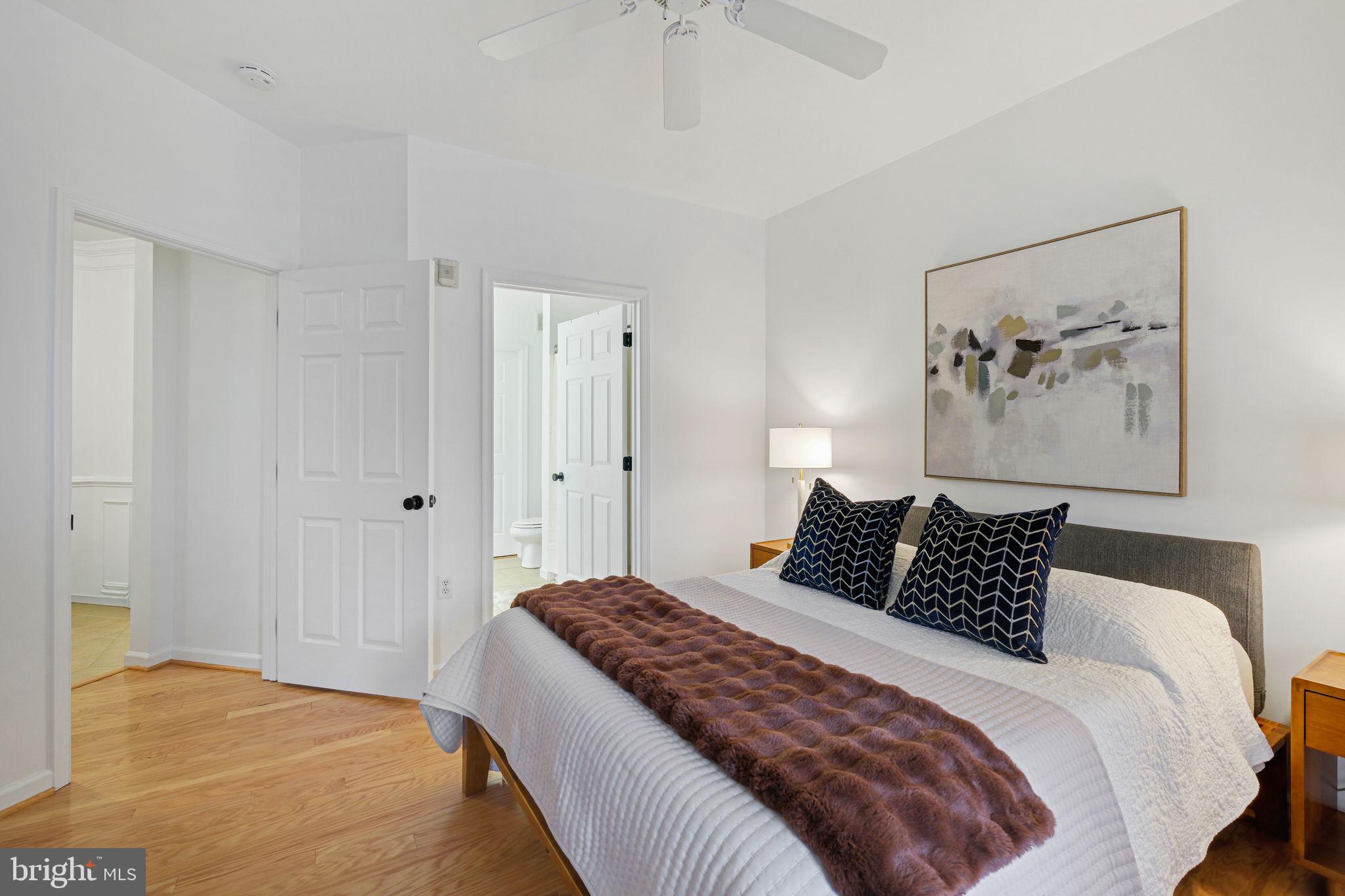 8 Granite Place, Unit 266 Gaithersburg, MD 20878 - Photo 17 of 49 a bedroom with a large bed and a painting on the wall