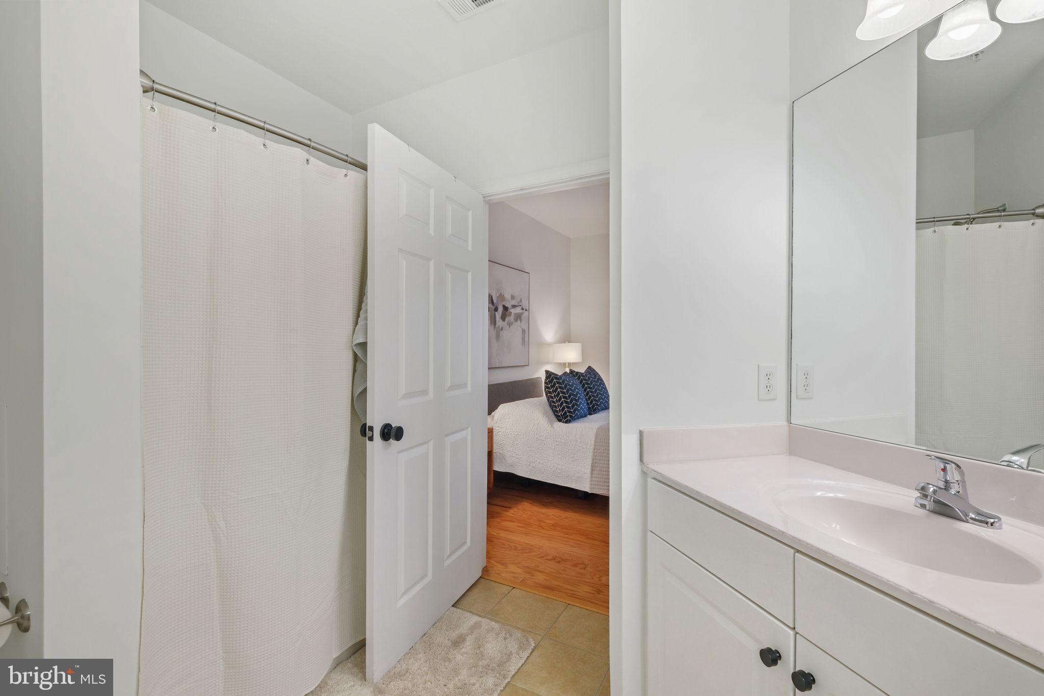 8 Granite Place, Unit 266 Gaithersburg, MD 20878 - Photo 19 of 49 a en suite bathroom with a granite countertop sink and a mirror