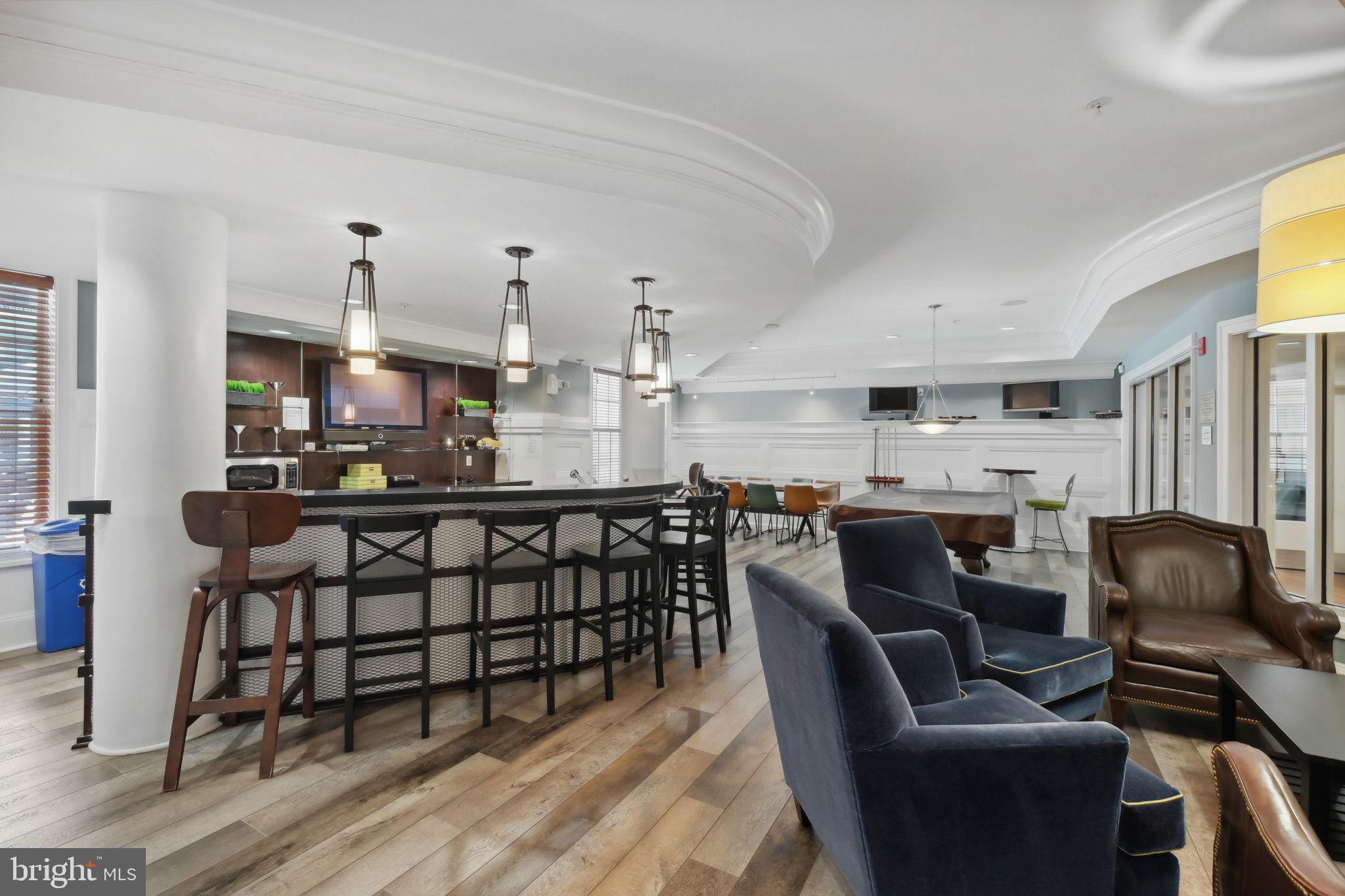 8 Granite Place, Unit 266 Gaithersburg, MD 20878 - Photo 32 of 49 a kitchen with stainless steel appliances kitchen island granite countertop a dining table chairs sink and cabinets