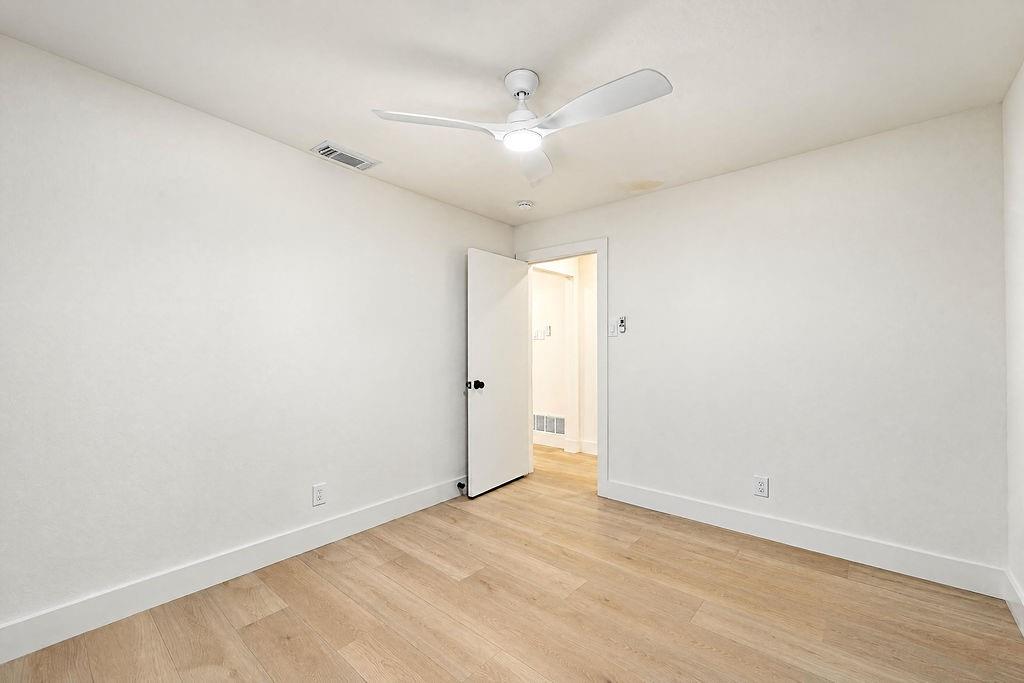 1904 Apollo Road Richardson, TX 75081 - Photo 28 of 40 Wood-finish flooring with white baseboards and painted walls