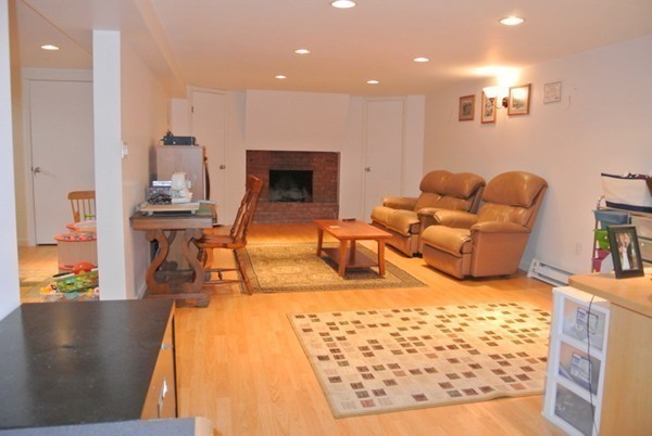 251 High St Extension Lancaster, MA 01523 - Photo 14 of 18 a living room with furniture rug and a fireplace