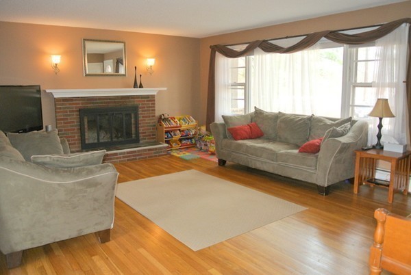 251 High St Extension Lancaster, MA 01523 - Photo 5 of 18 a living room with furniture and a fireplace