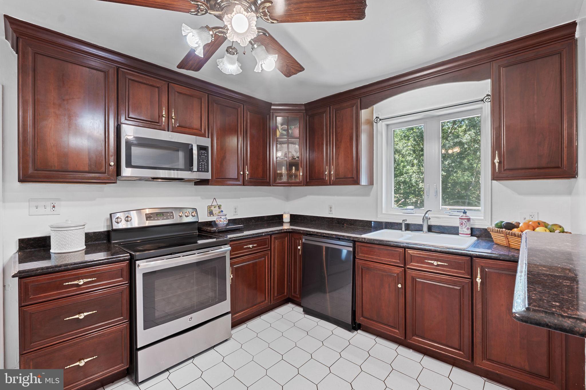 23439 Watson Road Leesburg, VA 20175 - Photo 11 of 41 a kitchen with a sink stove and microwave