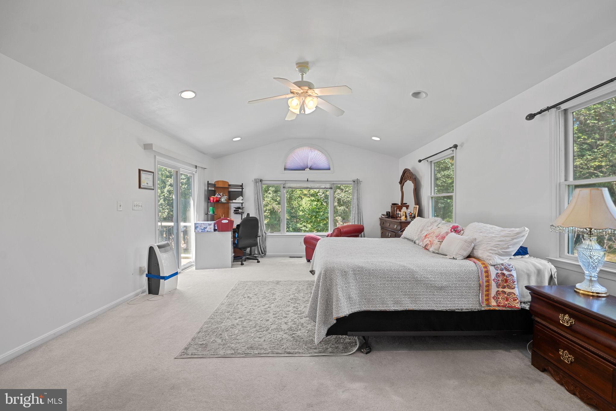 23439 Watson Road Leesburg, VA 20175 - Photo 18 of 41 a bedroom with a bed and a chandelier