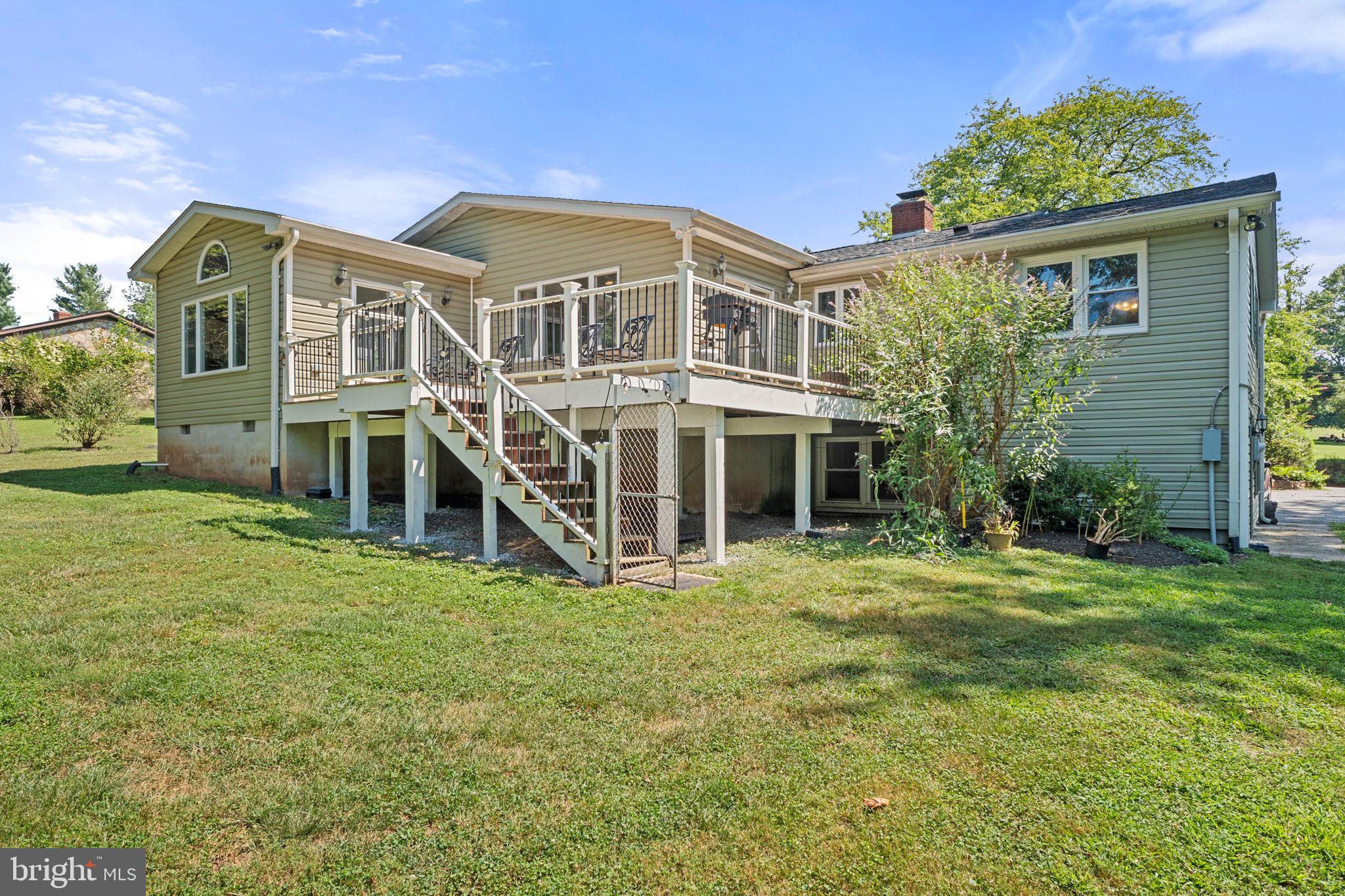 23439 Watson Road Leesburg, VA 20175 - Photo 2 of 41 a large brick building with a big yard and large trees