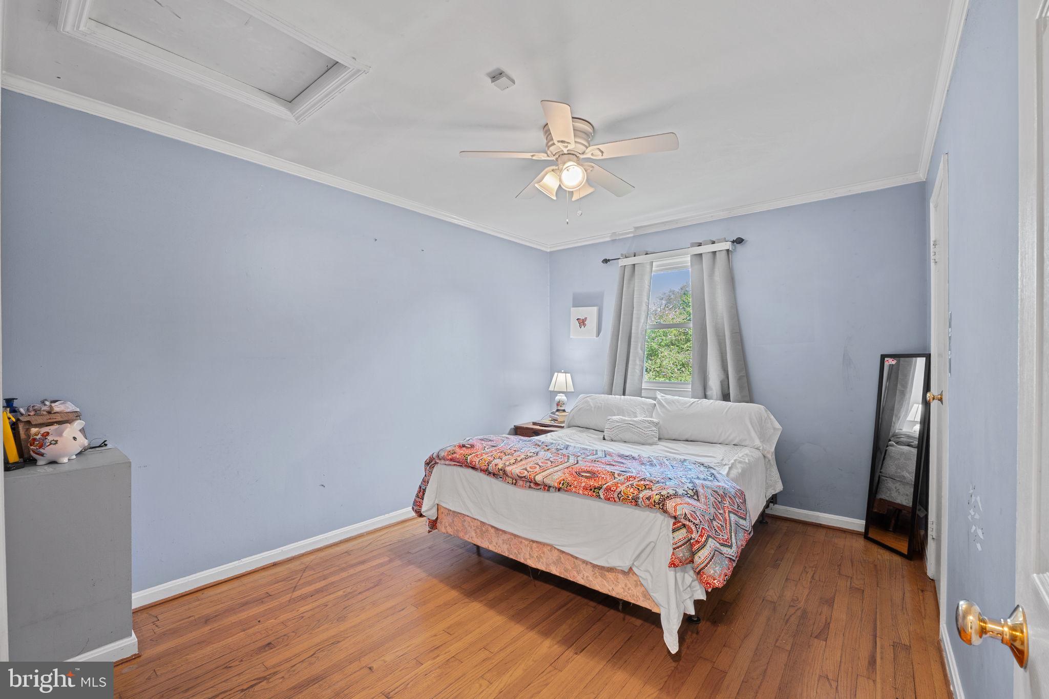 23439 Watson Road Leesburg, VA 20175 - Photo 24 of 41 a bedroom with a bed chandelier and a window