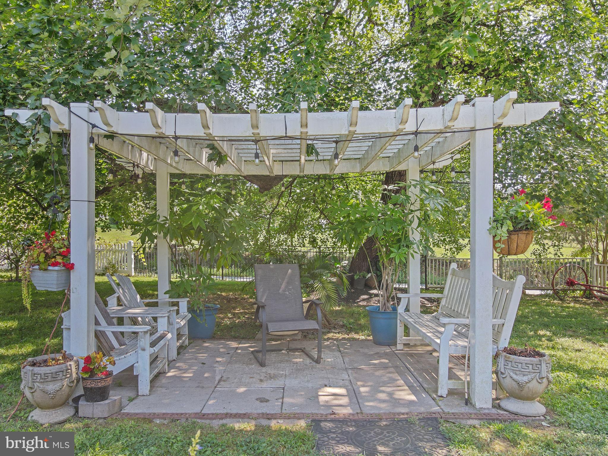 23439 Watson Road Leesburg, VA 20175 - Photo 40 of 41 a backyard of a house with lots of green space and outdoor seating
