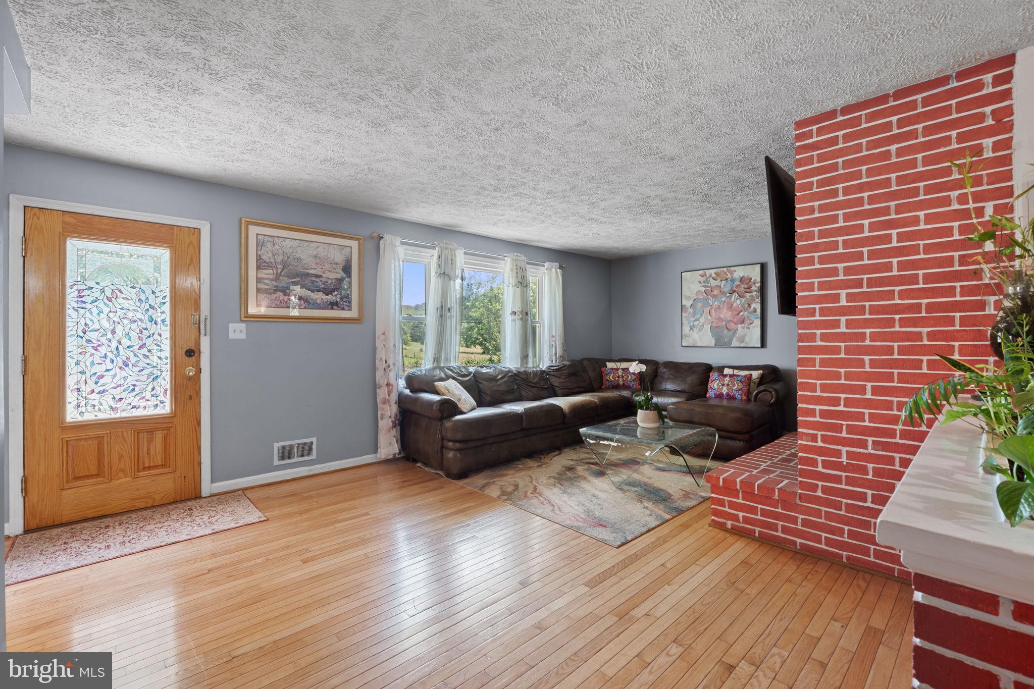 23439 Watson Road Leesburg, VA 20175 - Photo 7 of 41 a living room with furniture and wooden floor