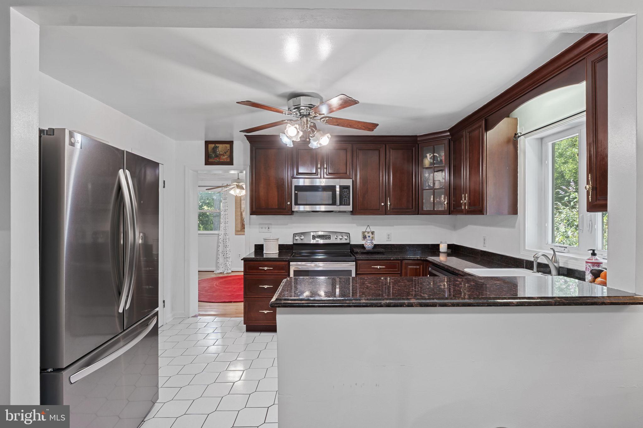 23439 Watson Road Leesburg, VA 20175 - Photo 10 of 41 a kitchen with stainless steel appliances granite countertop a sink refrigerator and microwave