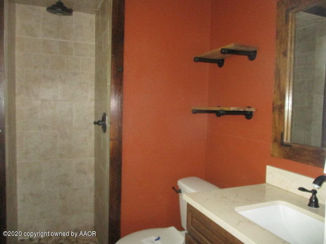 8108 Coronado Trail Amarillo, TX 79110 - Photo 11 of 14 a bathroom with a sink toilet and shower