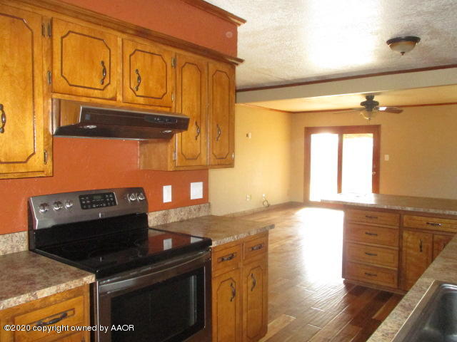 8108 Coronado Trail Amarillo, TX 79110 - Photo 7 of 14 a kitchen with stainless steel appliances granite countertop a stove and a sink