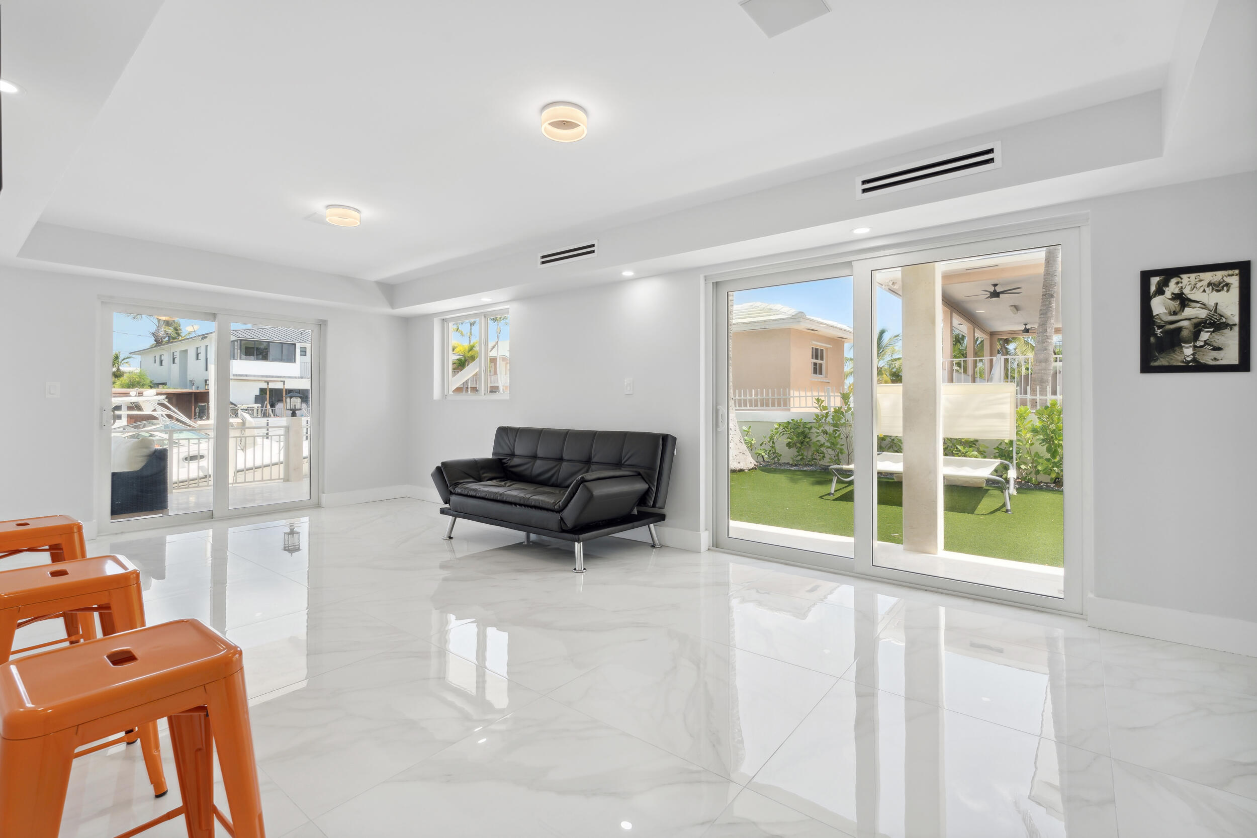 238 Atlantic Boulevard Key Largo, FL 33037 - Photo 21 of 104 a living room with furniture and a floor to ceiling window