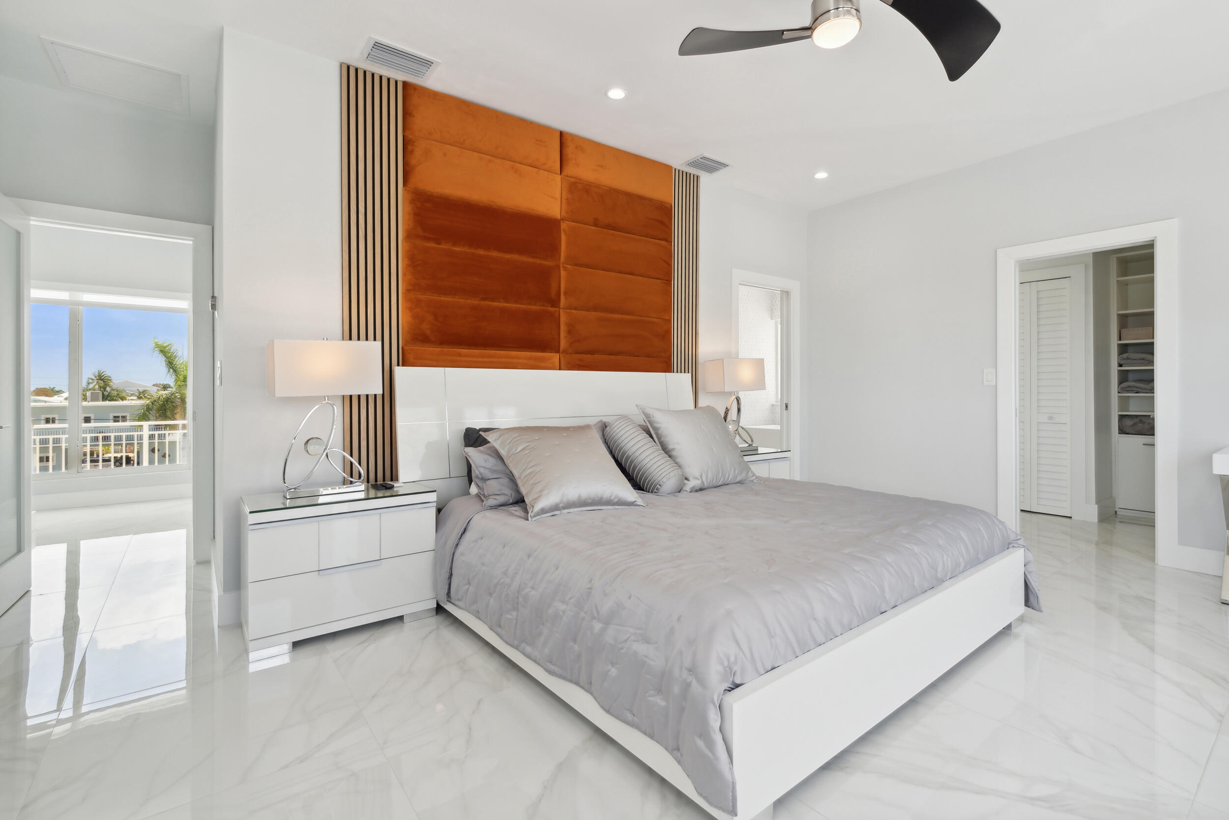 238 Atlantic Boulevard Key Largo, FL 33037 - Photo 45 of 104 a spacious bedroom with a large bed and a chandelier