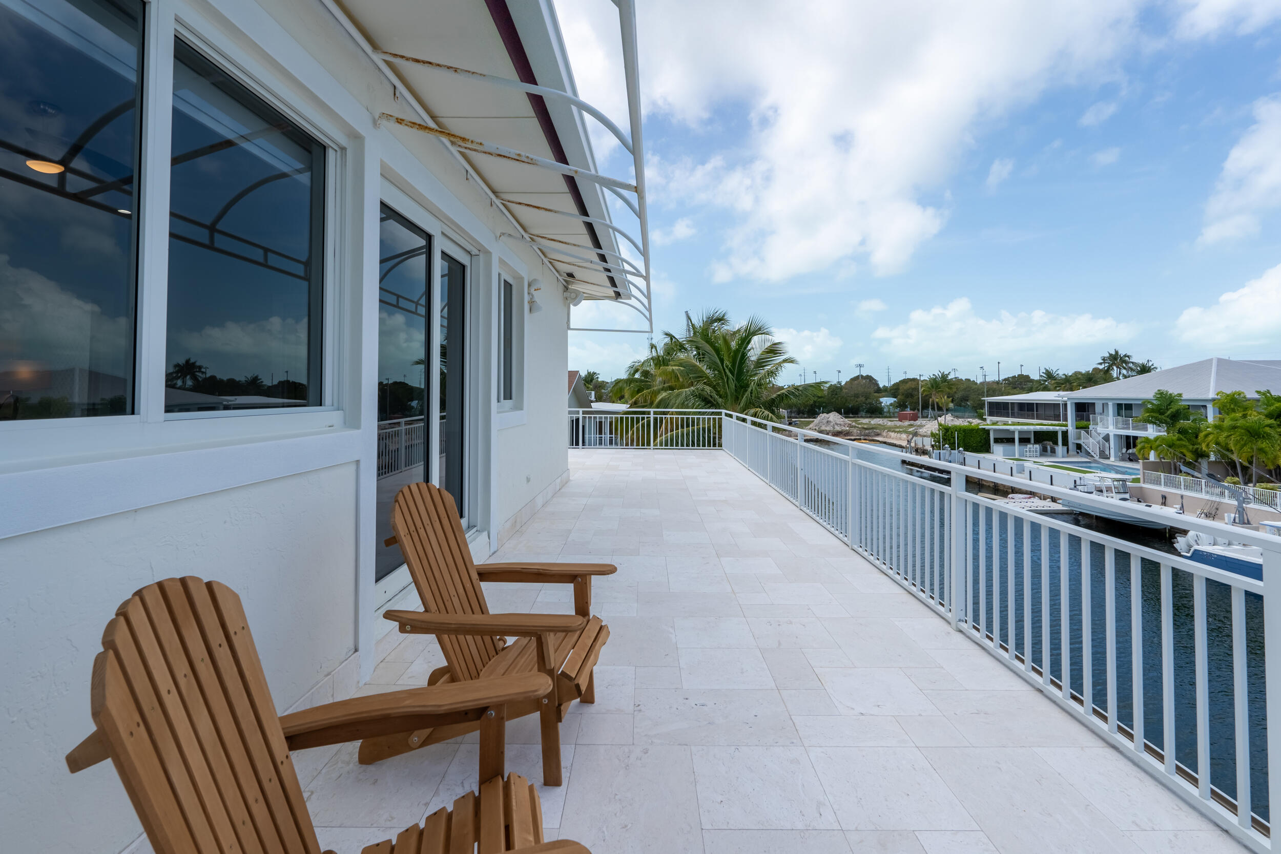 238 Atlantic Boulevard Key Largo, FL 33037 - Photo 61 of 104 a view of a chair and tables in the balcony