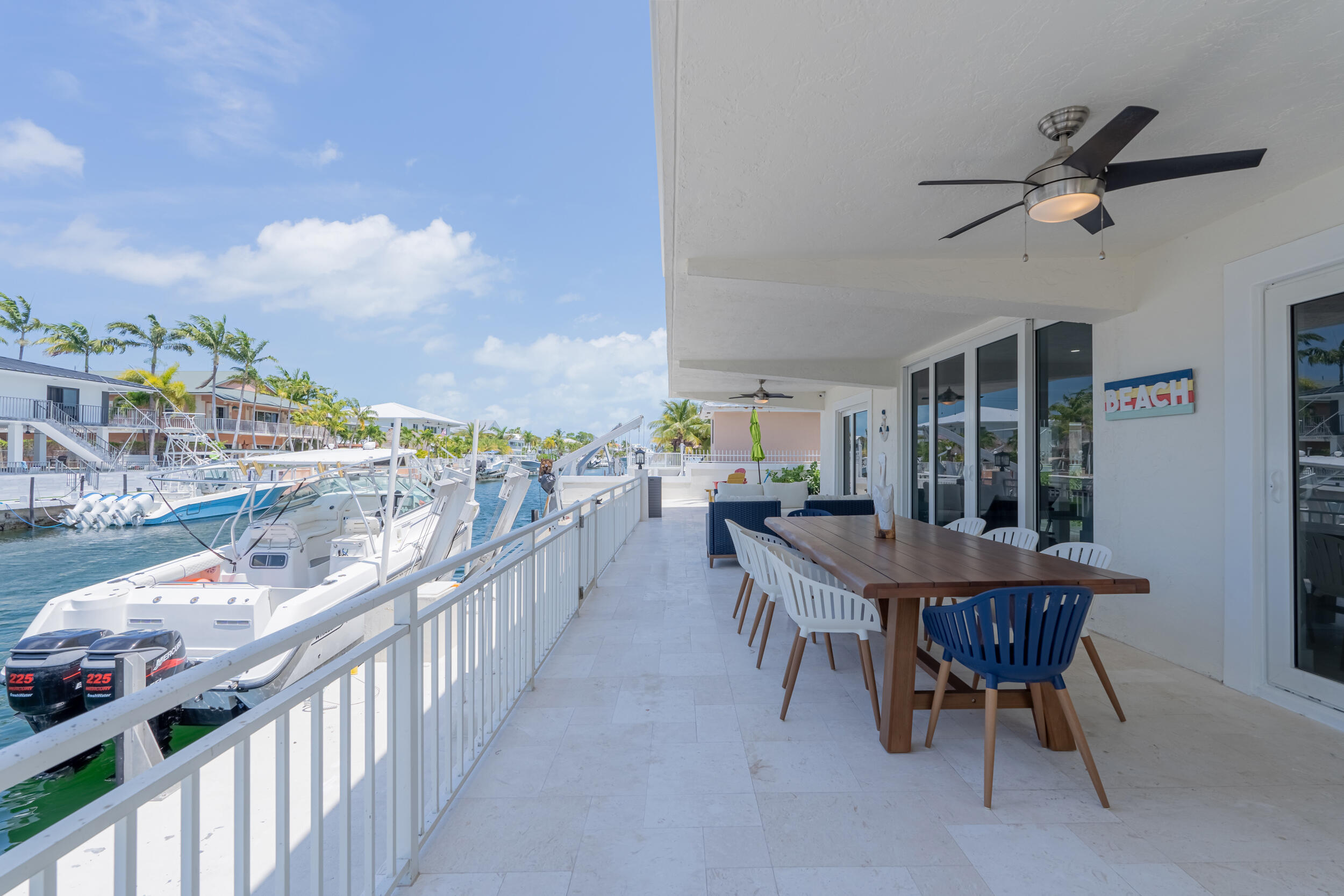238 Atlantic Boulevard Key Largo, FL 33037 - Photo 74 of 104 a dining room with furniture and a floor to ceiling window