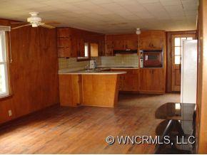 282 Mica Ridge Sylva, NC 28779 - Photo 7 of 11 a kitchen with granite countertop a refrigerator and a stove