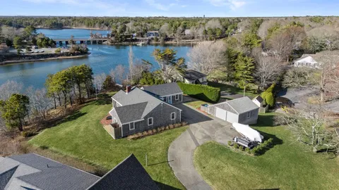 an aerial view of a house with outdoor space and a lake view