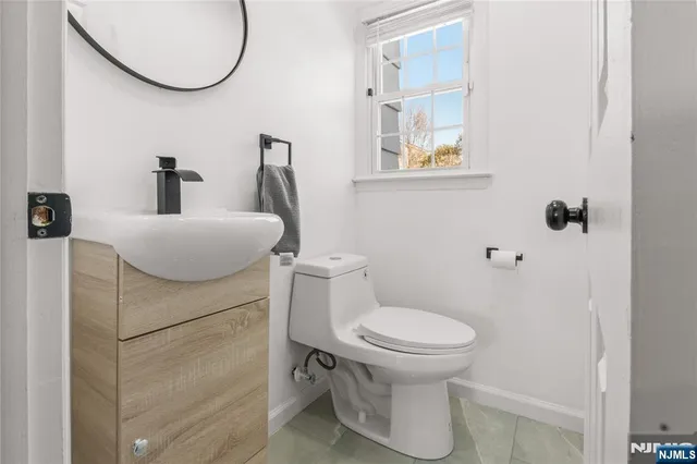 a bathroom with a toilet and a mirror