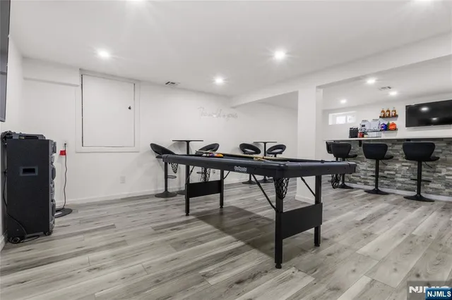 a view of a workspace with furniture and wooden floor