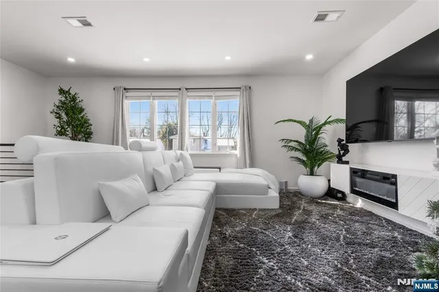 a living room with furniture potted plant and a window