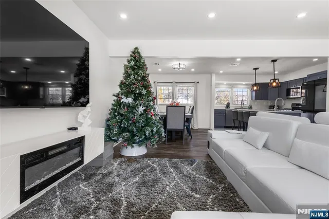 a living room with furniture potted plant and a fireplace