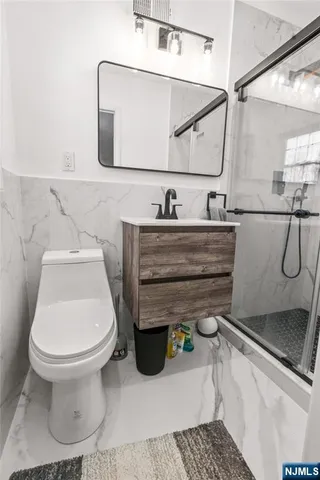 a bathroom with a sink toilet and mirror