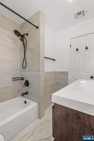 a bathroom with a bathtub and a shower