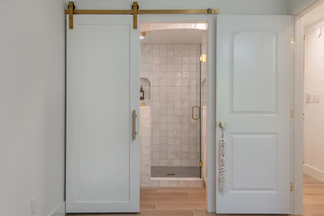 a bathroom with a glass shower door