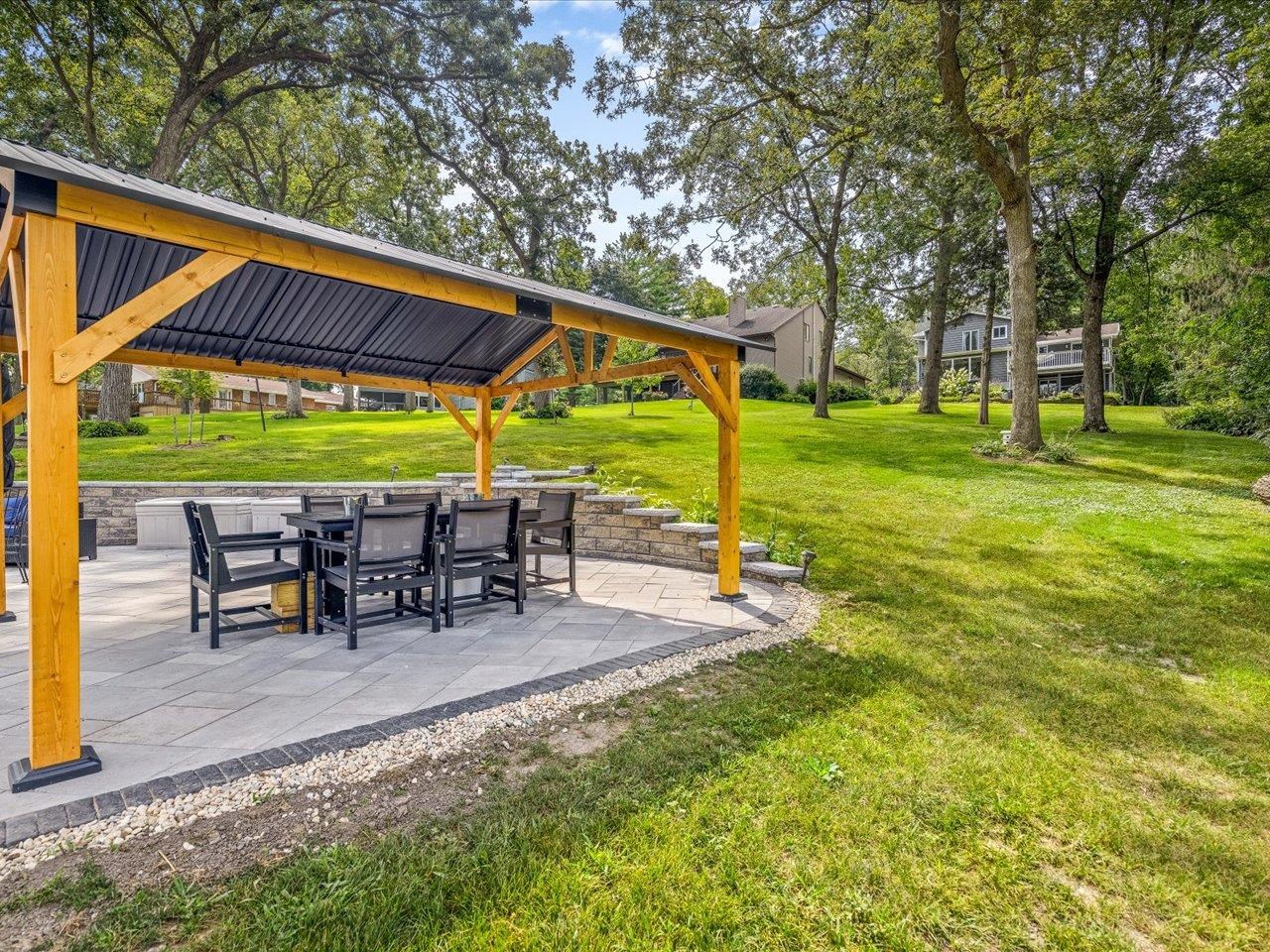 1950 Baintree Road Lake Summerset, IL 61019 - Photo 52 of 61 a view of a patio with table and chairs under an umbrella