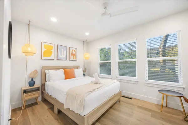 a bedroom with a bed and a large window