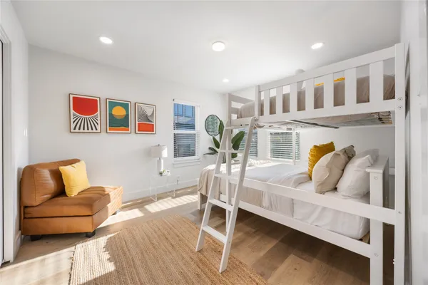 a bedroom with furniture and a wooden floor