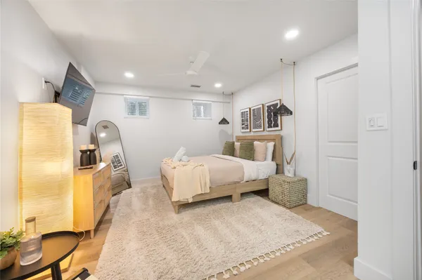 a bedroom with a bed and wooden floor