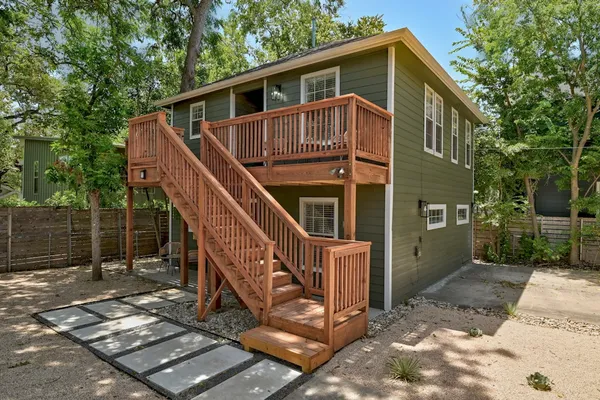 a front view of a house with wooden fence