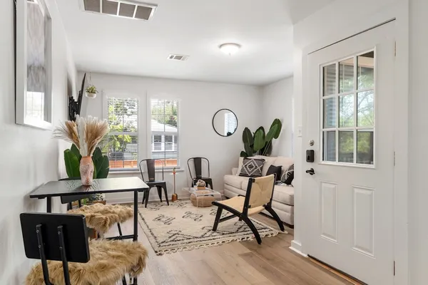 a living room with furniture and kitchen view