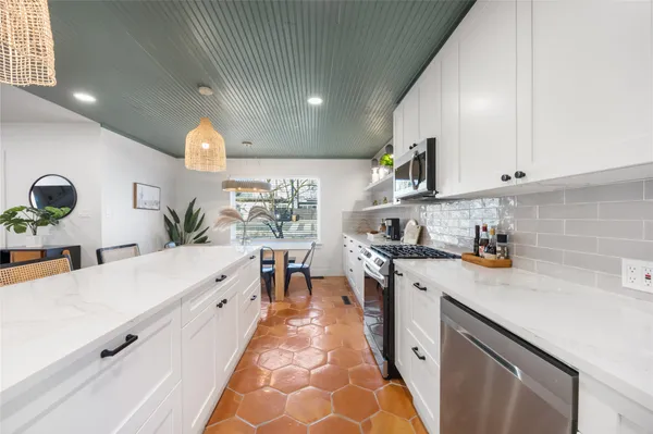 a kitchen with appliances and cabinets
