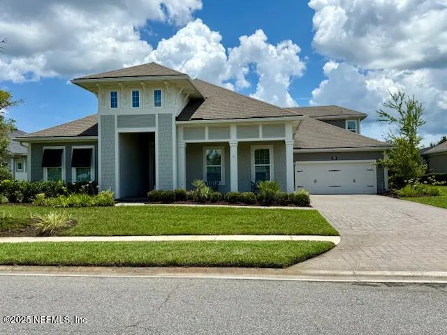 a front view of a house with a garden and plants