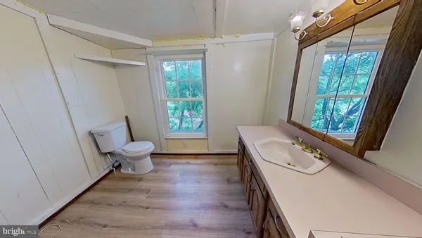 a bathroom with a sink a toilet and a shower