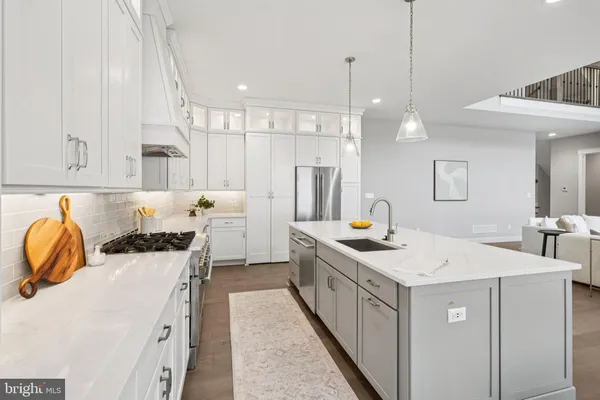 a kitchen with a sink a stove and cabinets