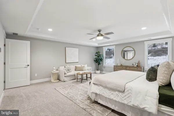 a bedroom with a large bed and chandelier